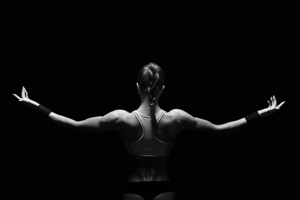 Athletic young woman showing muscles of the back — Stock Photo, Image