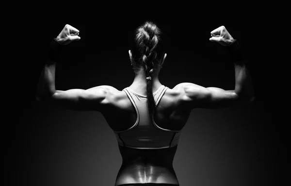 Athletic young woman showing muscles of the back — Stock Photo, Image