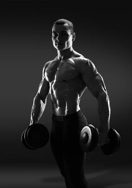 Handsome power athletic man bodybuilder doing exercises with dum — Stock Photo, Image