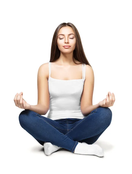 Happy young woman sitting in lotus position — Stock Photo, Image