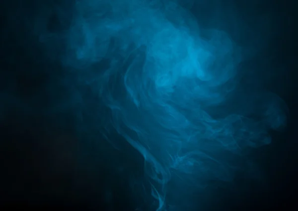 Blue smoke over black studio background — Stock Photo, Image