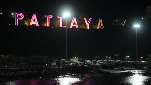 Pattaya, Thailand - 10 maart 2016: Het neon teken in nachttijd van Pattaya city en kleurrijke reflectie in het zeewater — Stockvideo