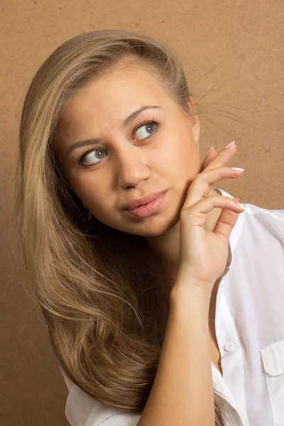 Attractive beautiful young woman with long hair  wearing jeans — Stock Photo, Image