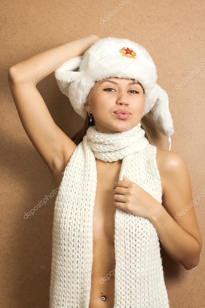 Beautiful crazy girl in fur hat. grins, speaks maliciously