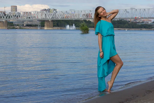 Attractive girl have fun at the urban beach in the water. Woman portrait with blue dress. — Stock Photo, Image