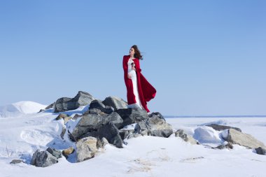 Kadın beyaz elbise kumaş uçan kırmızı ile sallayarak