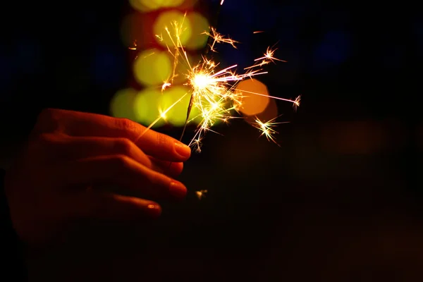 Holiday background with a sparkler — Stock Photo, Image