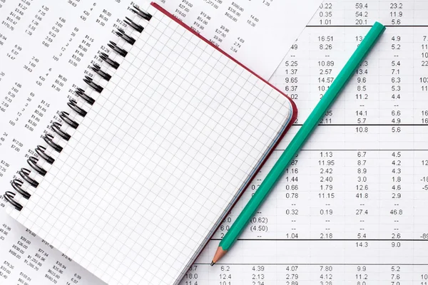 Pencil and notebook on financial chart. — Stock Photo, Image