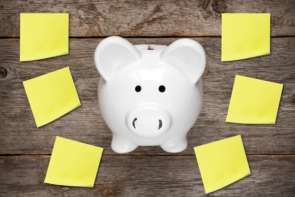 Piggy bank with sticky notes — Stock Photo, Image
