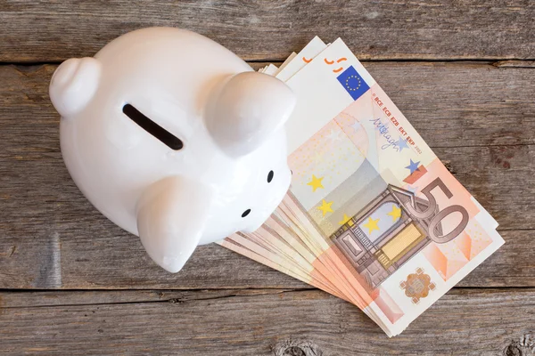 Piggy bank with 50 euro bills — Stock Photo, Image