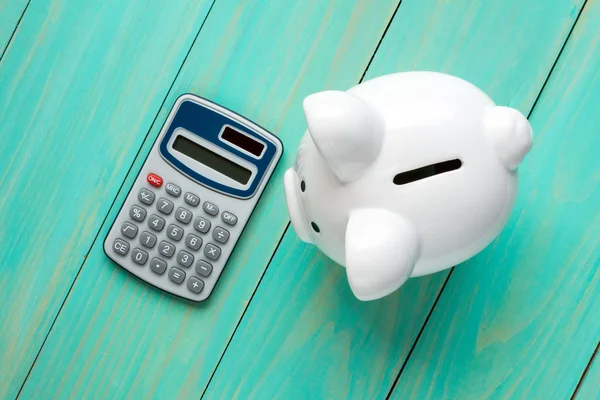 Piggy bank and calculator,top view — Stock Photo, Image