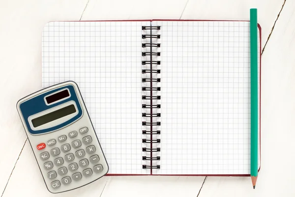 Digital calculator and spiral notebook — Stock Photo, Image