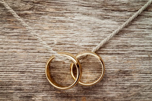 Wedding rings hanging on rope. — Stock Photo, Image