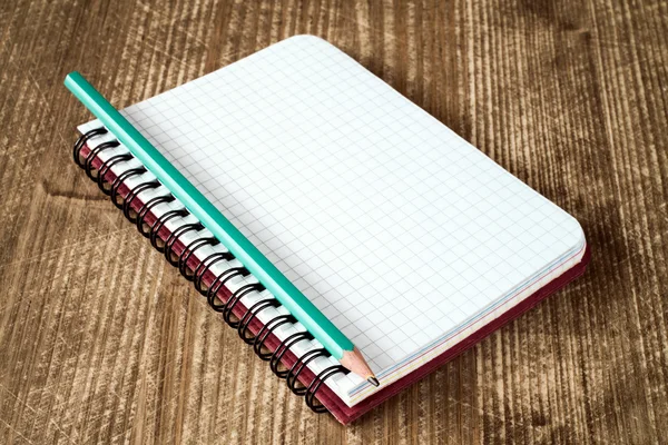 Close-up of spiral notebook and pencil . — Stok fotoğraf