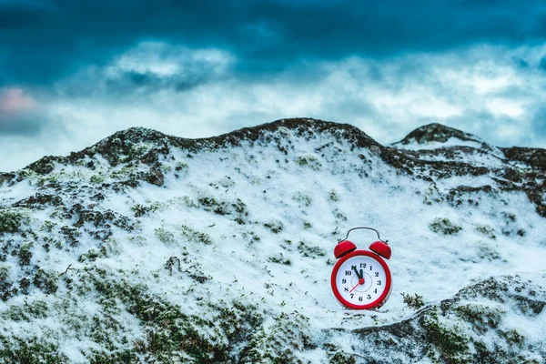 冻结的时间 大雪覆盖的岩石上的闹钟 极端天气状况 冬季时间 — 图库照片