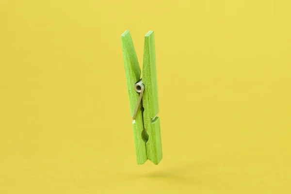 Green Wooden Clothes Peg Yellow Background — Stock Photo, Image