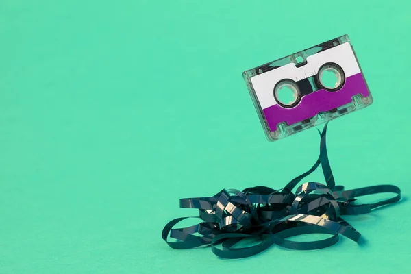 Purple Cassette Pulled Out Tape Blue Background — 스톡 사진