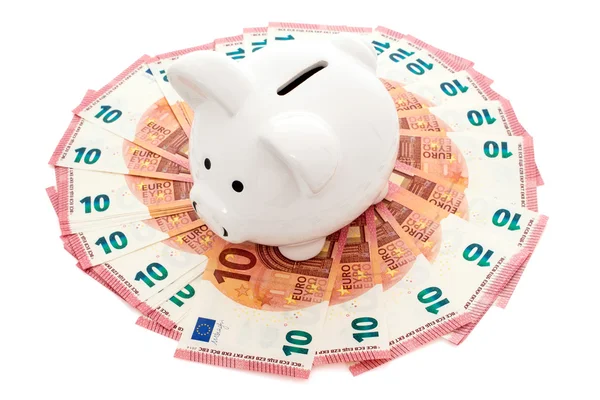 Piggy bank surrounded by ten Euros notes — Stock Photo, Image