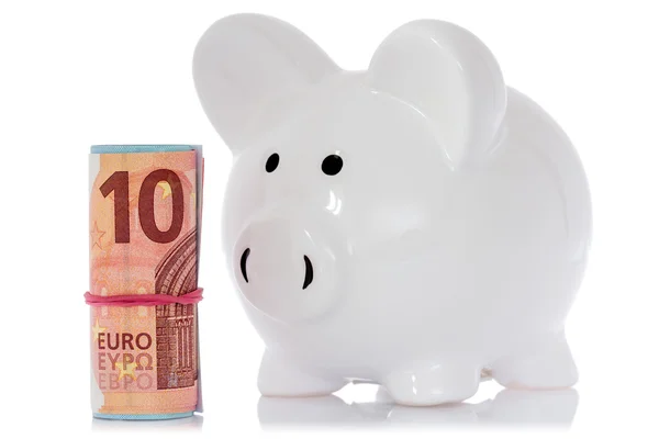 Piggy bank with money roll — Stock Photo, Image