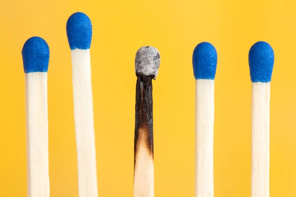 Four matches and one burnt — Stock Photo, Image