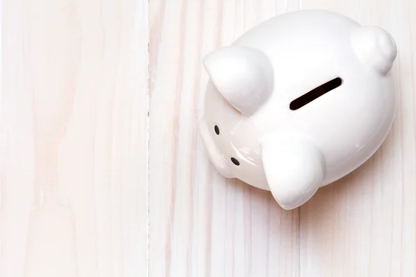 Piggy bank on the white wooden background — Stock Photo, Image