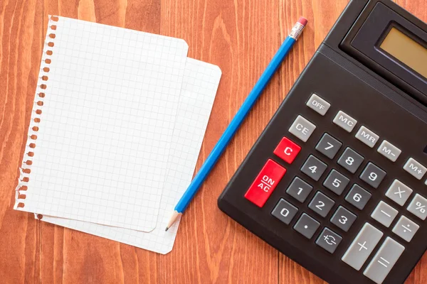 Paper sheets and calculator — Stock Photo, Image