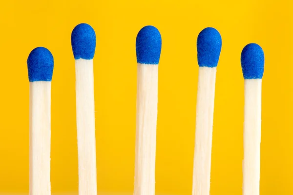 Five matchsticks on yellow background — Stock Photo, Image