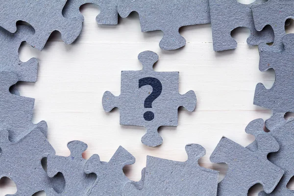 Jigsaw puzzle and question mark — Stock Photo, Image