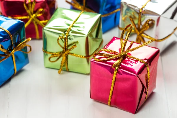 Small gift boxes on white wood background — Stock Photo, Image