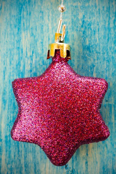 Christmas bauble hanging on wooden background — Stock Photo, Image