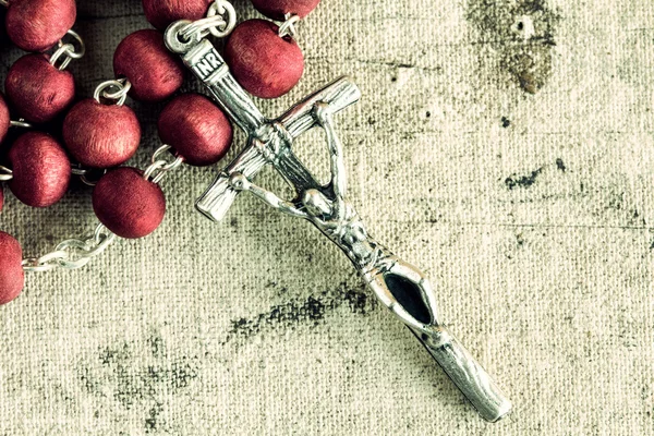Rosary on dirty canvas — Stock Photo, Image
