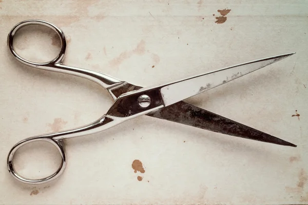 Old scissors on a paper background — Stock Photo, Image