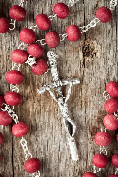 Rosary on old wooden texture — Stock Photo, Image