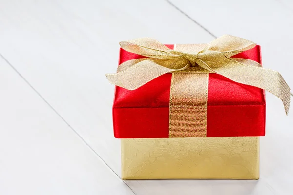 Giftbox on white wooden background — Stock Photo, Image