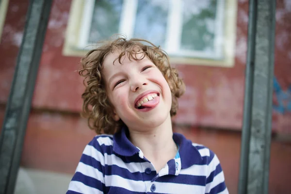 Мальчик смеется с высунутым языком — стоковое фото