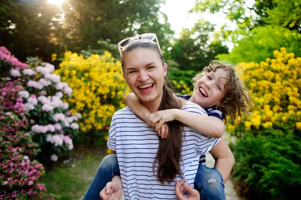 Young woman walking with her son. — Stockfoto