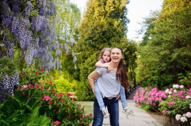 madre e hija caminando en el parque de verano