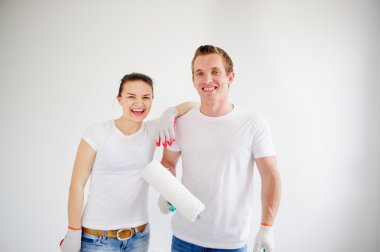 Young cheerful couple is ready to repair.