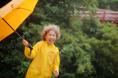 8-9 yaşında bir şemsiye yağmur durmak için bir el ile çocuk.