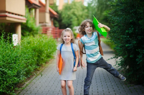 Två barn har roligt på vägen till skolan. — Stockfoto