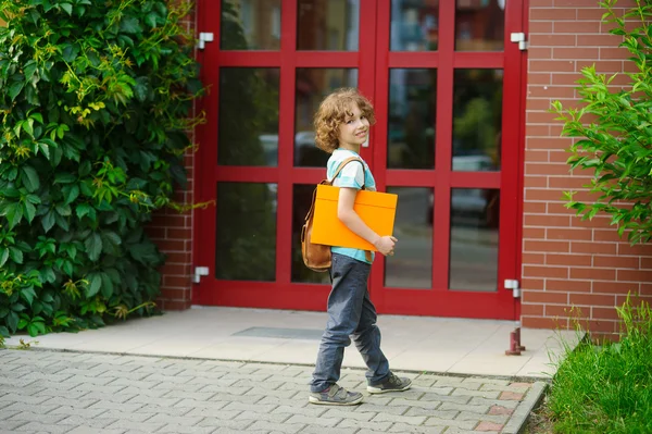 Cheerful first grader coming to the school door. — Stock Photo, Image