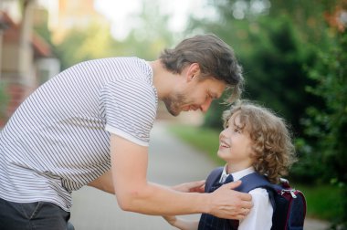 Father escorts to school, first-grader son clipart