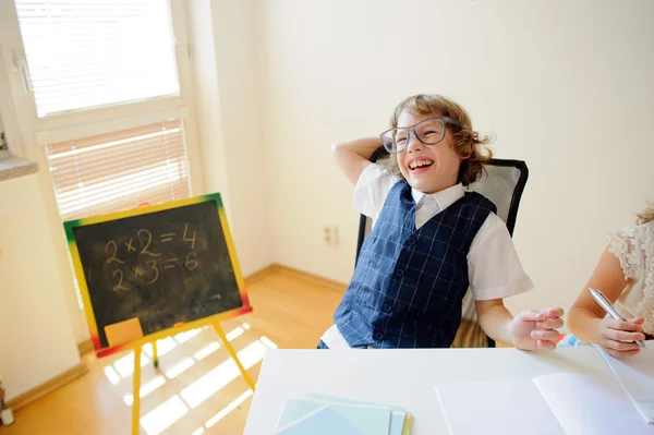 Travieso colegial en gafas se ríe alegremente . —  Fotos de Stock