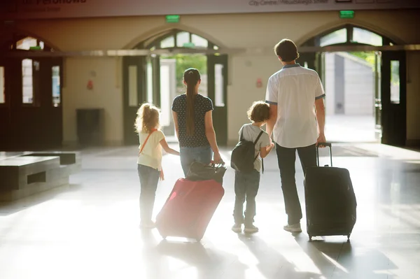 Young family in the waiting room at the station.
