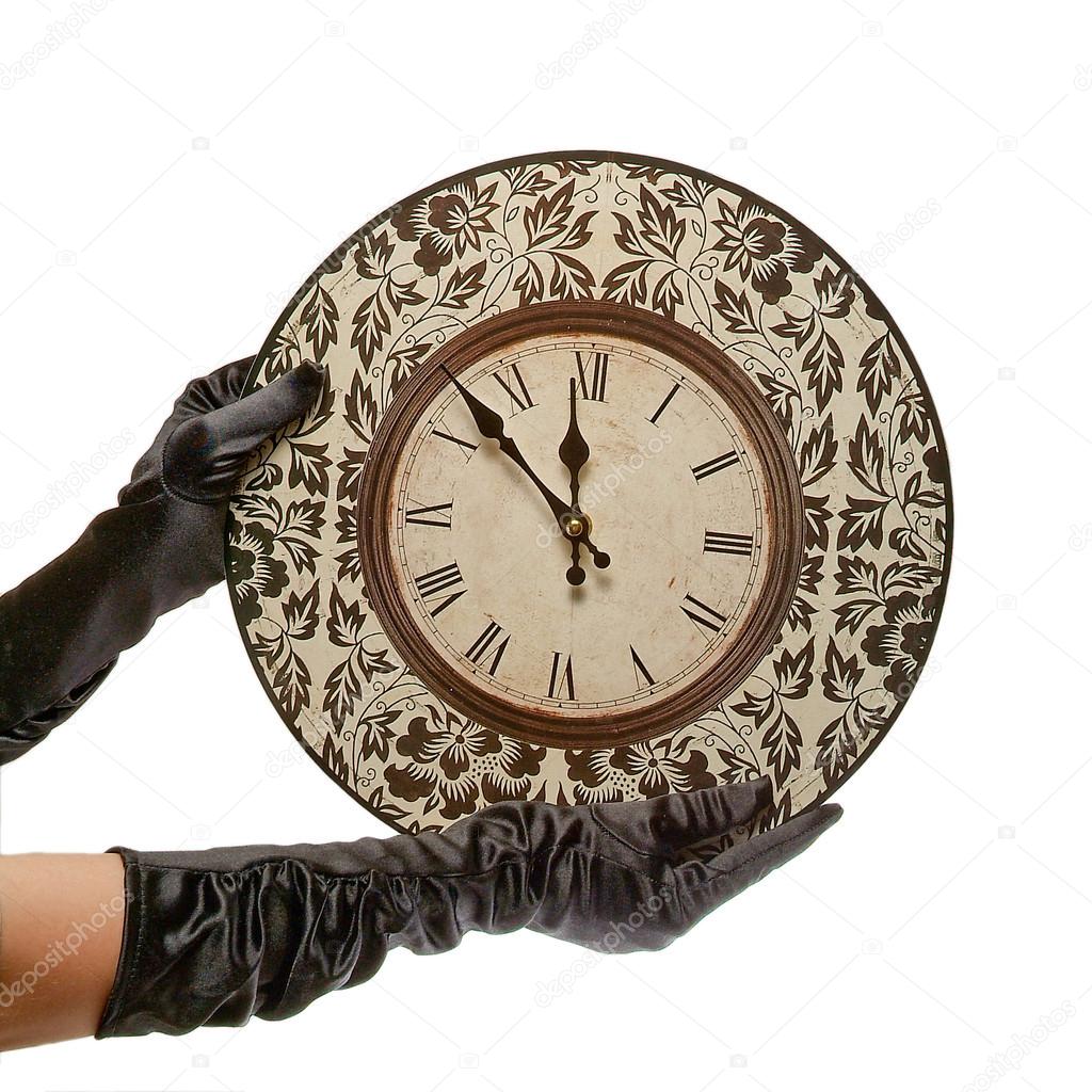 hands in black gloves hold retro clock. isolated on white backgr