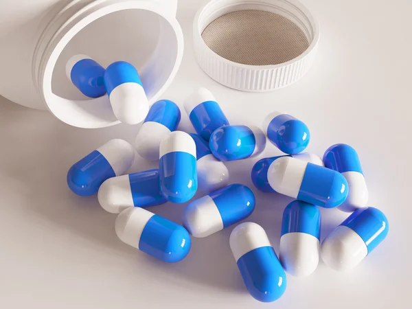 Színes tabletták egy pirulát üveg fehér háttér Stock Fotó