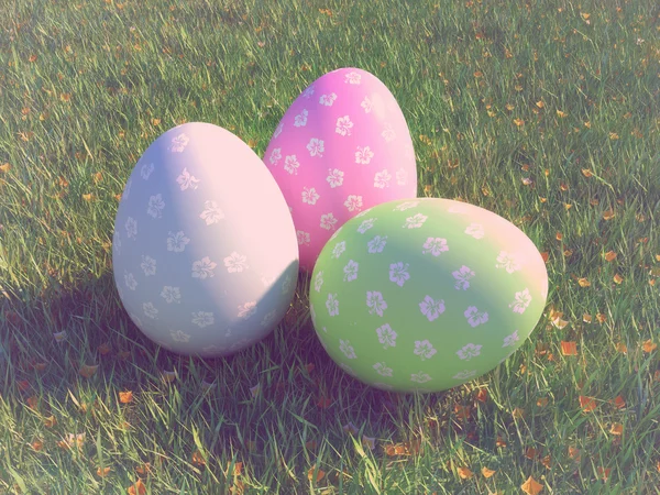 Easter eggs and daisies in the grass — Stock Photo, Image