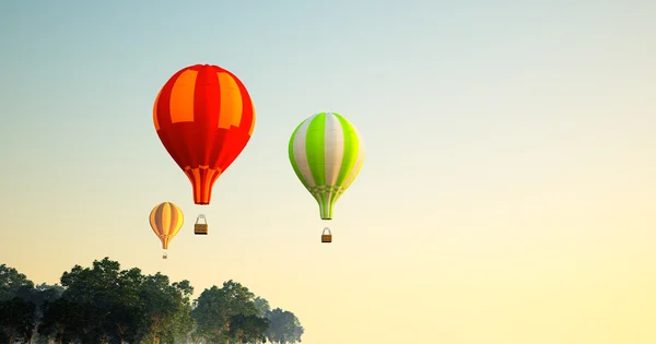 A lot of balloons flight over forest — Stock Photo, Image