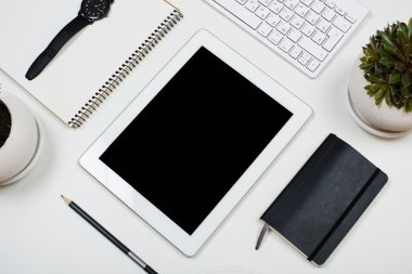 Beyaz masa üstü arka plan üzerinde tablet mock-up ve ofis malzemeleri