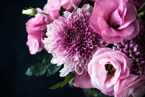 Bouquet of pink flowers closeup on black background — Stock Photo, Image